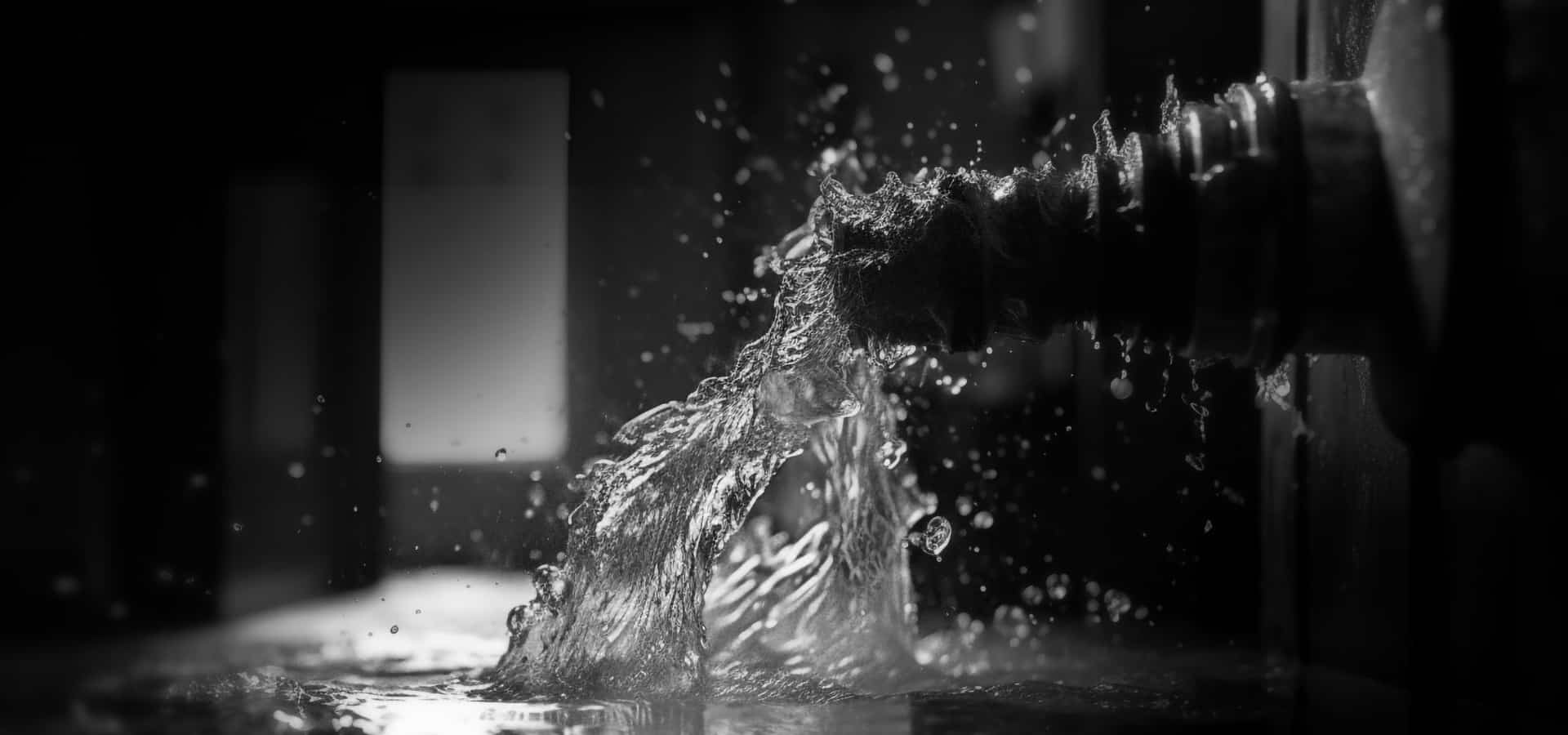 a black and white photo of a water fountain
